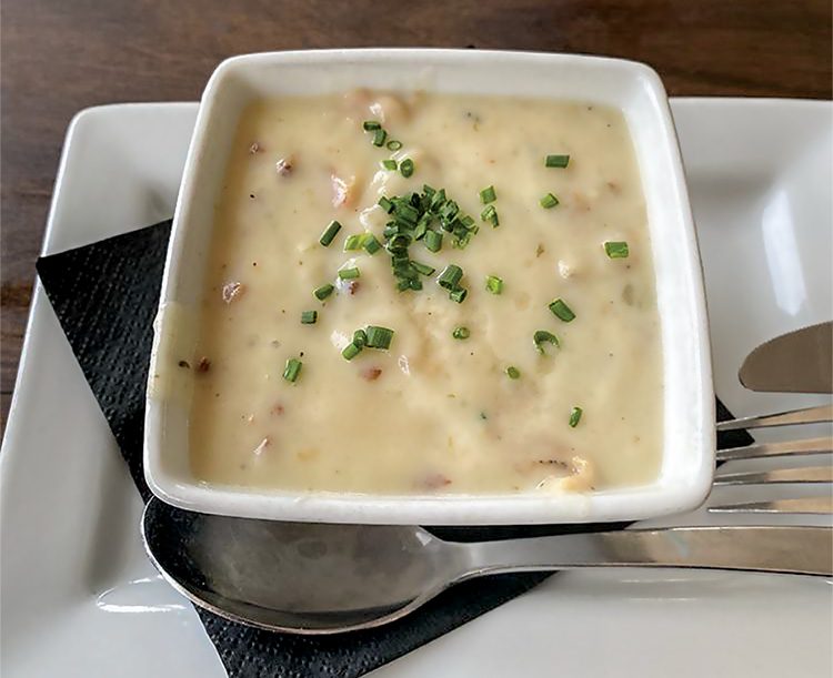 Blue Water’s creamy clam chowder with smoked bacon, potatoes andonions topped with fresh herbs and dry sherry. Photo by Olga G. for Yelp.