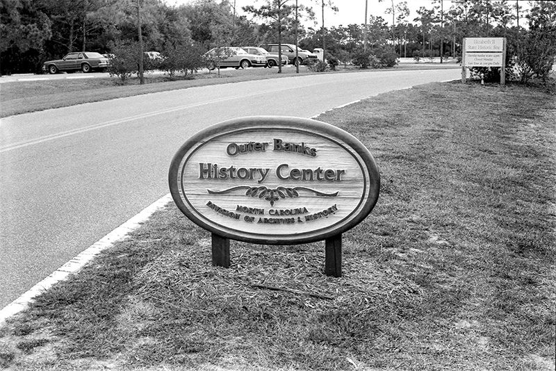 Exterior sign of newly built Outer Banks History Center facility adjacent to the Elizabeth II Historic Site on Ice Plant Island across from downtown Manteo (Roanoke Island Festival Park was later built connected to the OBHC in 1998 to replace the Elizabeth II site). Image courtesy of Outer Banks History Center staff photos.