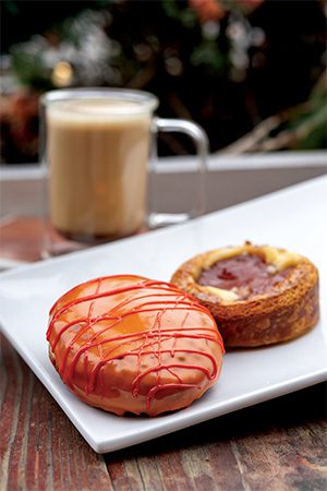 Proof Bakery’s Brown Butter Latte, here featured with two seasonal offerings: Poached Pear w/Mascarpone Cream Danish & Cranberry Orange Berliner.