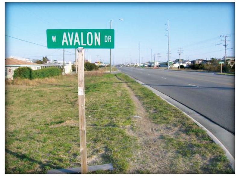 Worn path shows pedestrian demand along US 158 despite the lack of a sidewalk. Table 2.4 and image courtesy of KDH Pedestrian Plan.