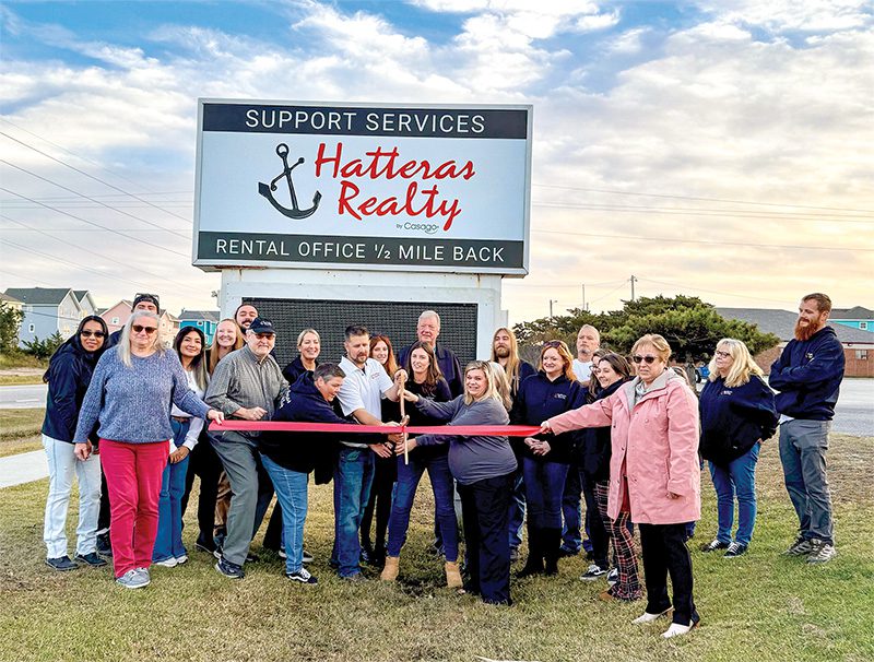 The Hatteras Realty team rejoices as they cut the Chamber of Commerce ribbon, marking the comeback of local leadership at the iconic brand.