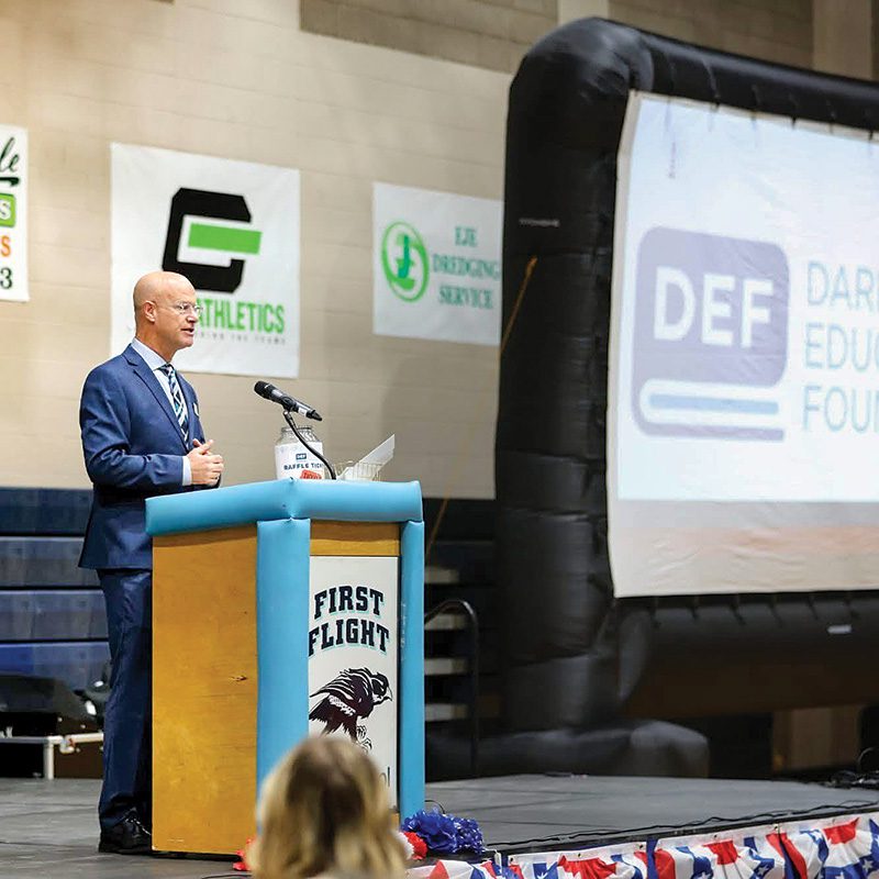 Ben Sproul takes the stage to greet teachers during a professional development day for Dare County Schools in February. The event at First Flight High School was one of Sproul's first in his new role of Executive Director of the Dare Education Foundation.