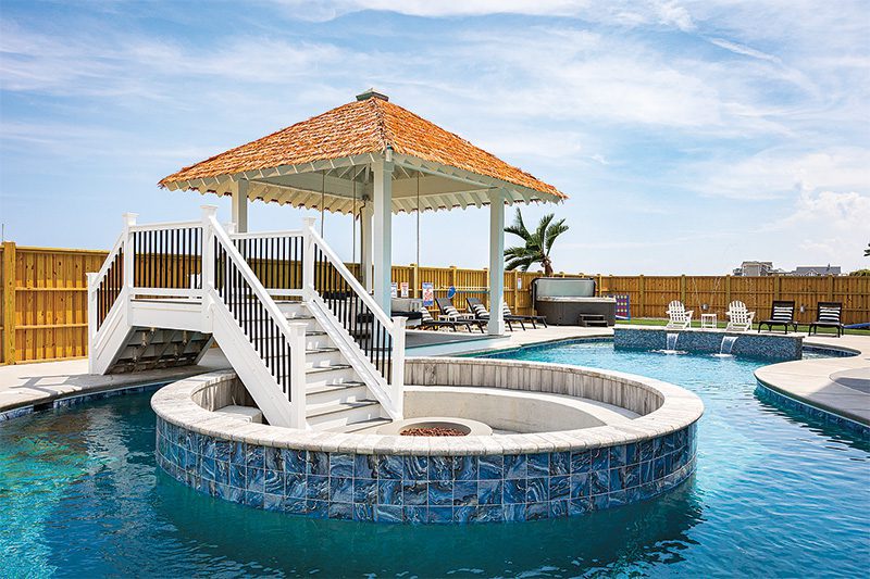 Dune Buggy’s in-pool firepit creates a built-in focal point—something guests don’t expect and won’t forget. Image from Twiddy & Company.
