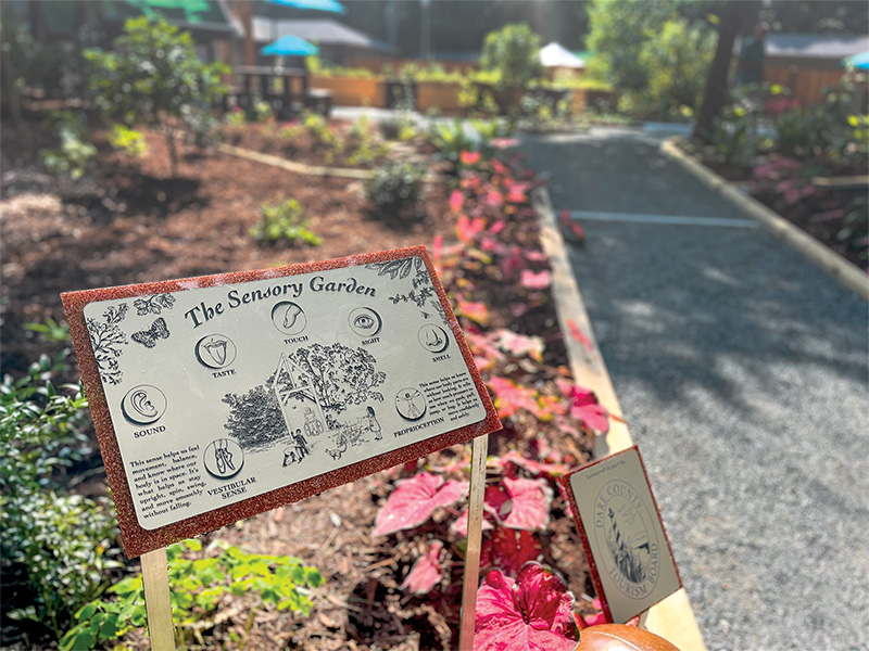 The Sensory Garden at The Elizabethan Gardens in Manteo invites visitors of all ages to engage with nature through touch, scent, and sound, supported in part by Dare County Tourism Board funding.
