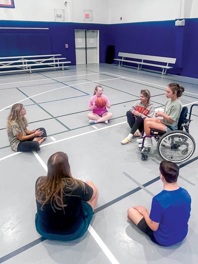 Campers in the gym playing “Duck, Duck, Goose”.