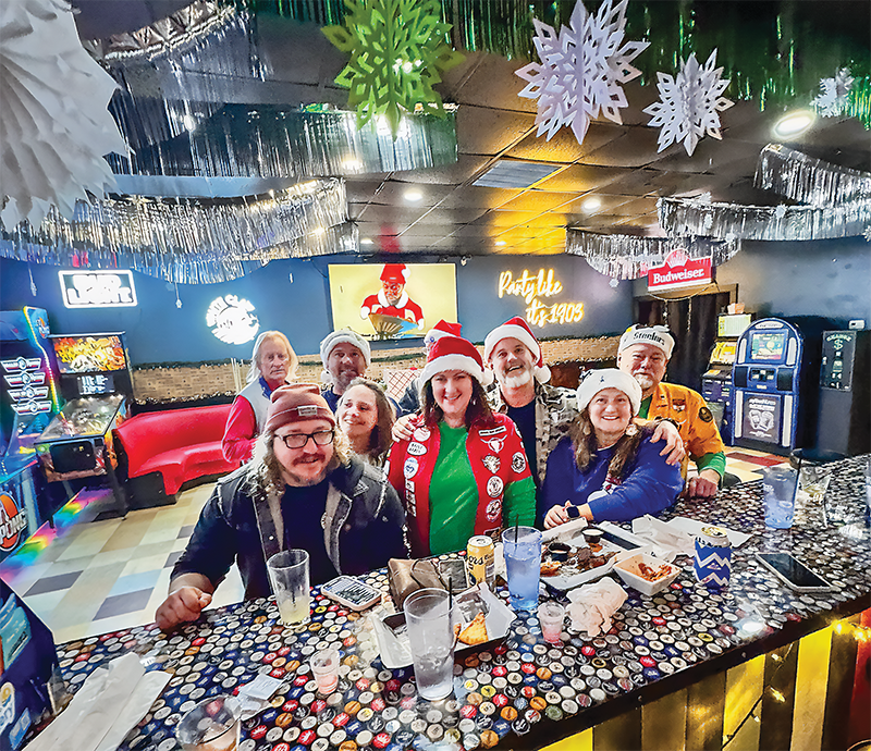 Revelers gather for Christmas cocktails at 1903 Bar and Kitchen, which is one of the "Festive Four" pop-up bars making spirits bright—or is that making bright spirits?—across the Outer Banks this November and December.