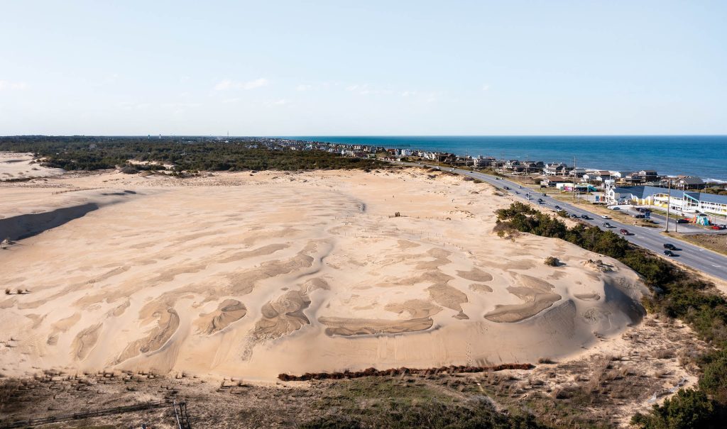 Aerial view of Jockeys Ridge State Park Sand Dunes Looking Across Highway 12 to the Ocean