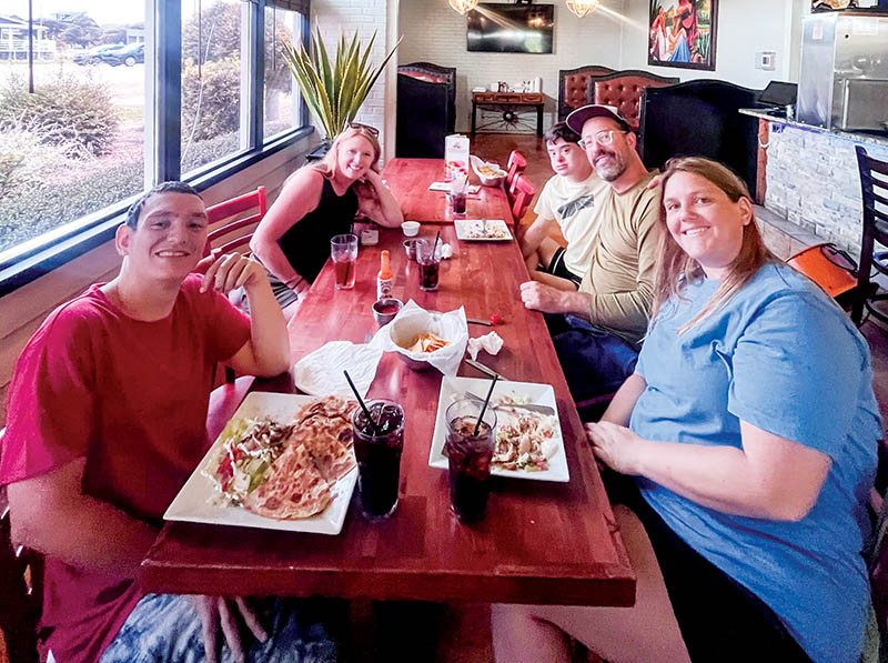 Camp students at Three Tequilas, engaged in an exercise to practice ordering at a restaurant.