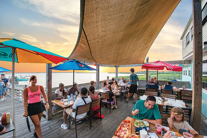 Few places capture the spirit of the Outer Banks quite like Miller's Waterfront Restaurant. With open-air seating along the Roanoke Sound and dock access for visiting boaters, it's the perfect spot to enjoy a meal surrounded by coastal scenery.